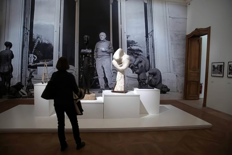 Visitors examine the artworks in the Picasso National Museum